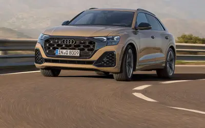 Audi Q8 front three-quarter view in a mountain setting
