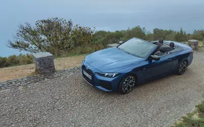 BMW M440i xDrive Convertible rear three-quarter view with the roof down