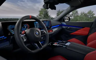 BMW M5 cockpit with M steering wheel and red trim