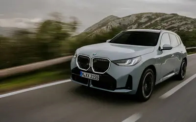 BMW X3 front three-quarter view on the move
