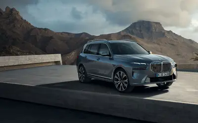 BMW X7 front three-quarter view in a mountain setting