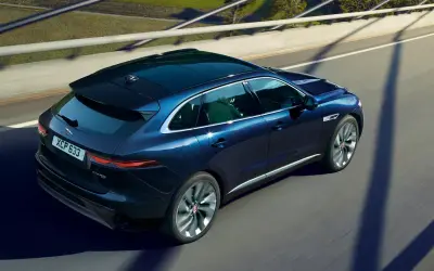 Jaguar F-Pace rear three-quarter view in dark blue, shot from above while moving