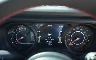 Jeep Wrangler interior view of the digital instrument cluster behind the steering wheel