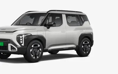 Kia Syros EV front three-quarter studio view showing the boxy EV3-inspired design and vertical LED headlamps