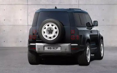 Land Rover Defender 110 rear view showing the side-hinged tailgate and mounted spare wheel