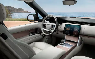 Range Rover front cabin with the curved centre touchscreen and light leather trim