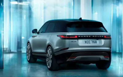 Range Rover Velar rear three-quarter view showing the full-width tail lamp bar