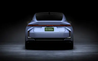 Lexus ES 500e rear studio view showing the full-width light bar