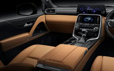 Lexus LX front cabin with tan leather seats and the dual-screen console