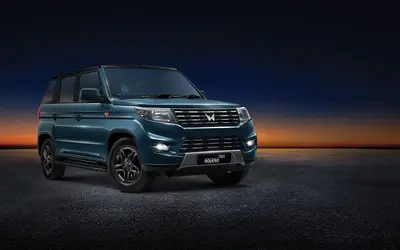 Mahindra Bolero Neo front three-quarter view at dusk