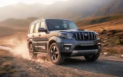 Mahindra Scorpio Classic driving on a desert road at sunset