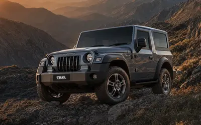 Mahindra Thar front three-quarter view on a mountain trail