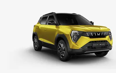 Mahindra XUV 3XO front three-quarter view in Citrine Yellow with Stealth Black roof