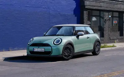 MINI Cooper 3-door in light green parked on a street, side three-quarter view