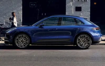 Porsche Macan side profile in blue on a city street