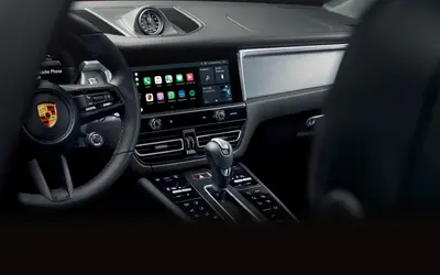 Porsche Macan cockpit with the centre touchscreen and dashboard-top clock