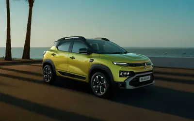 Renault Kiger 2025 facelift front three-quarter view in oasis yellow by the sea