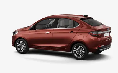 Tata Tigor rear three-quarter view in Classy Red