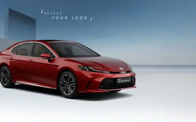 Toyota Camry front three-quarter view in Emotional Red