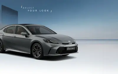 Toyota Camry front three-quarter view in Cement Grey