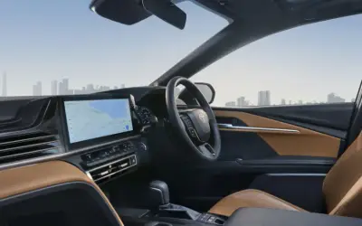 Toyota Camry dashboard with touchscreen and tan leather front seats