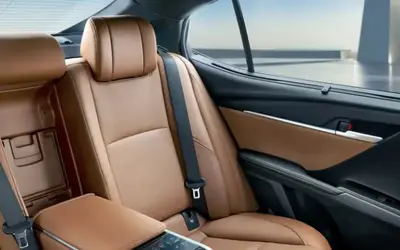 Toyota Camry rear seats in tan leather with centre armrest (cropped from official image)