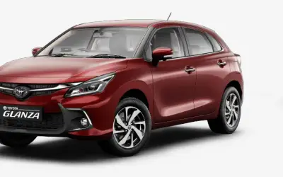 Toyota Glanza front three-quarter view in maroon
