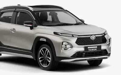 Toyota Urban Cruiser Taisor front three-quarter view in Cafe White with dual-tone black roof