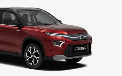Toyota Urban Cruiser Hyryder front three-quarter view in Sporting Red with Midnight Black roof
