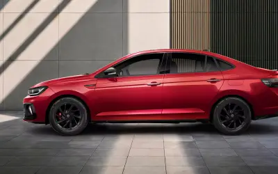 Volkswagen Virtus GT side profile in Wild Cherry Red with black alloy wheels