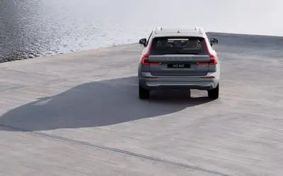 Volvo XC60 rear view on a concrete pier by the water