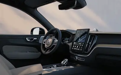 Volvo XC60 dashboard from the driver's side with the portrait touchscreen and wood trim