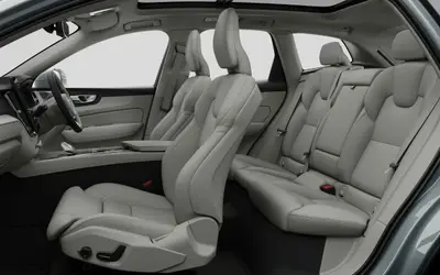 Volvo XC60 cabin seen from the side, front and rear seats in light upholstery